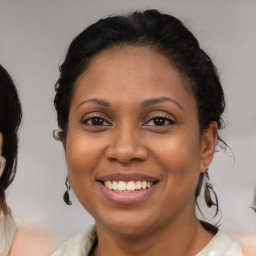 Joyful latino adult female with medium  brown hair and brown eyes