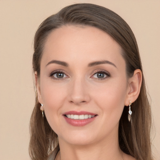 Joyful white young-adult female with long  brown hair and grey eyes