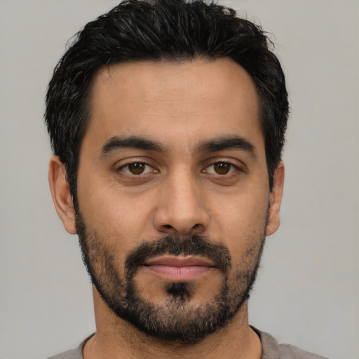 Neutral latino young-adult male with short  black hair and brown eyes