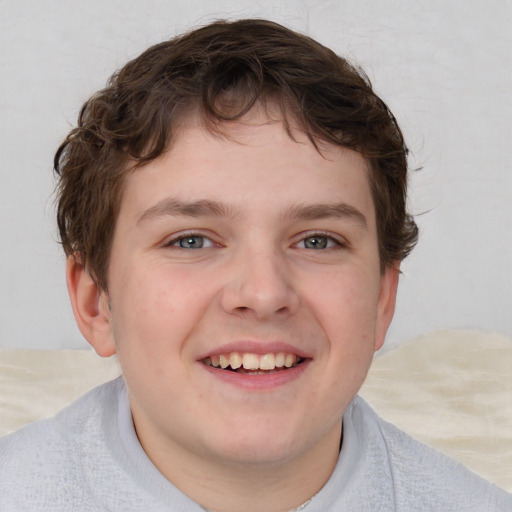 Joyful white young-adult male with short  brown hair and blue eyes