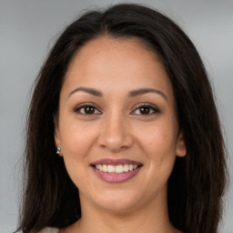 Joyful white young-adult female with long  brown hair and brown eyes