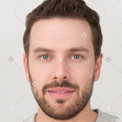 Joyful white young-adult male with short  brown hair and grey eyes