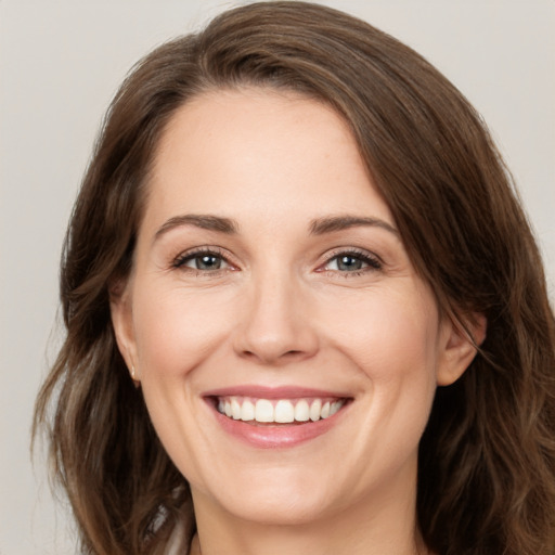 Joyful white young-adult female with medium  brown hair and green eyes