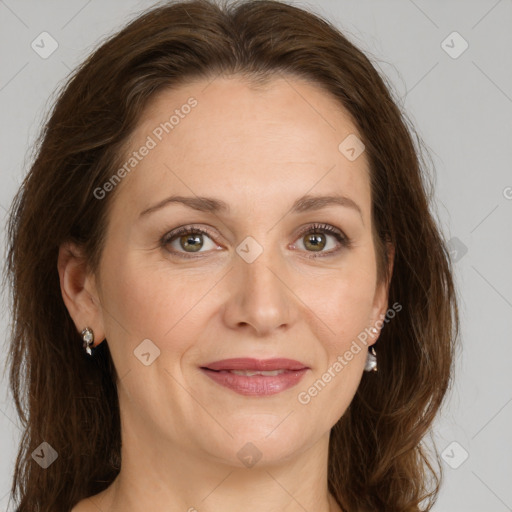 Joyful white adult female with long  brown hair and grey eyes