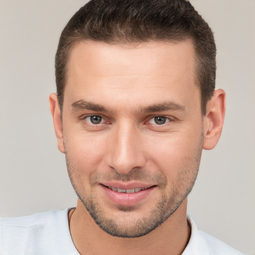 Joyful white young-adult male with short  brown hair and brown eyes