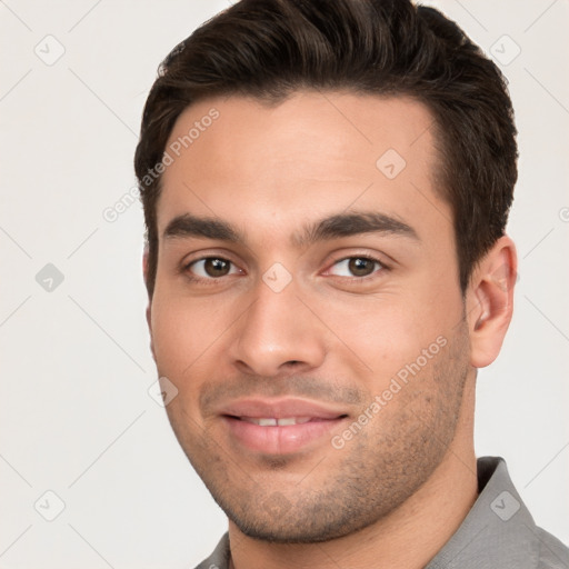 Joyful white young-adult male with short  brown hair and brown eyes