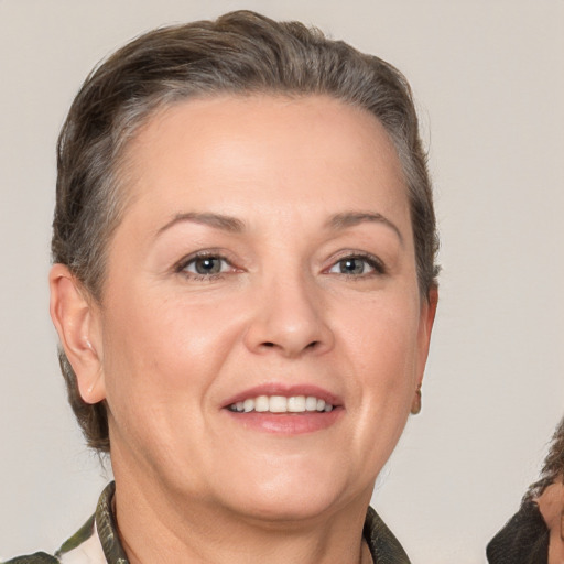 Joyful white adult female with short  brown hair and brown eyes