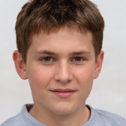 Joyful white child male with short  brown hair and brown eyes