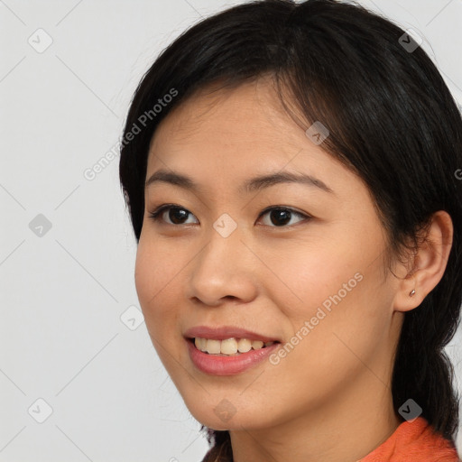 Joyful asian young-adult female with medium  black hair and brown eyes