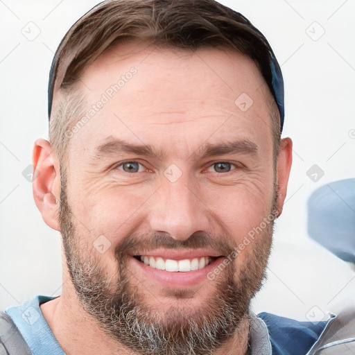 Joyful white adult male with short  brown hair and grey eyes