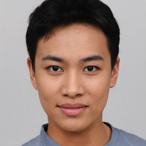 Joyful asian young-adult male with short  black hair and brown eyes