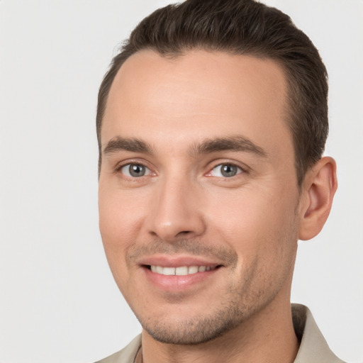 Joyful white young-adult male with short  brown hair and brown eyes