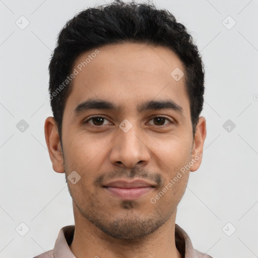 Joyful latino young-adult male with short  black hair and brown eyes