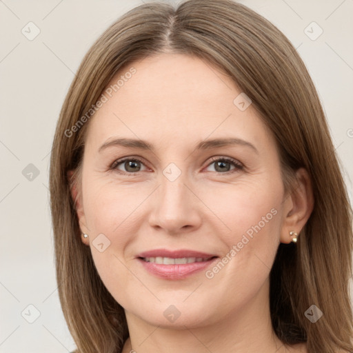 Joyful white adult female with long  brown hair and brown eyes