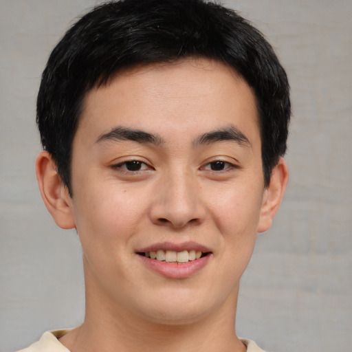 Joyful asian young-adult male with short  brown hair and brown eyes