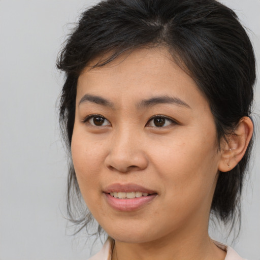Joyful asian young-adult female with medium  brown hair and brown eyes