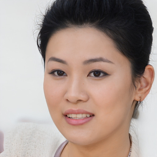 Joyful asian young-adult female with short  brown hair and brown eyes