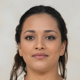 Joyful latino young-adult female with medium  brown hair and brown eyes