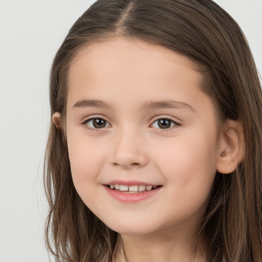 Joyful white child female with long  brown hair and brown eyes