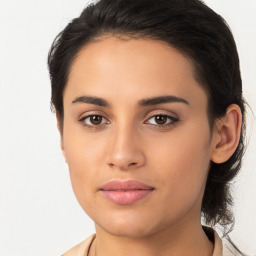 Joyful latino young-adult female with medium  brown hair and brown eyes