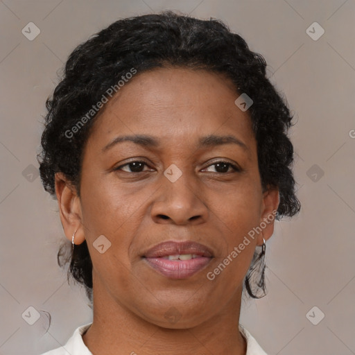 Joyful black adult female with short  brown hair and brown eyes