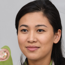 Joyful asian young-adult female with medium  brown hair and brown eyes