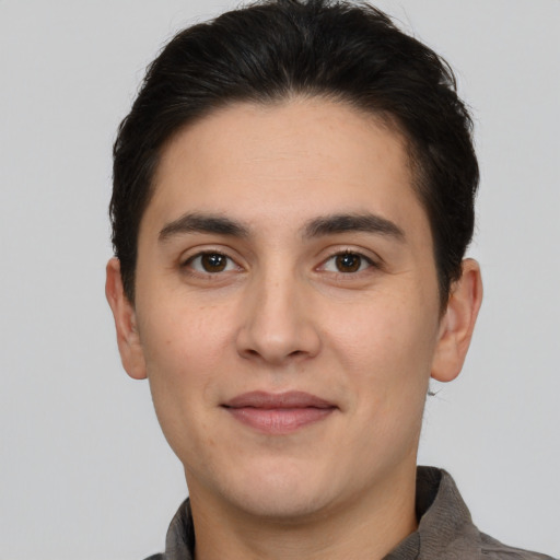 Joyful white young-adult male with short  brown hair and brown eyes