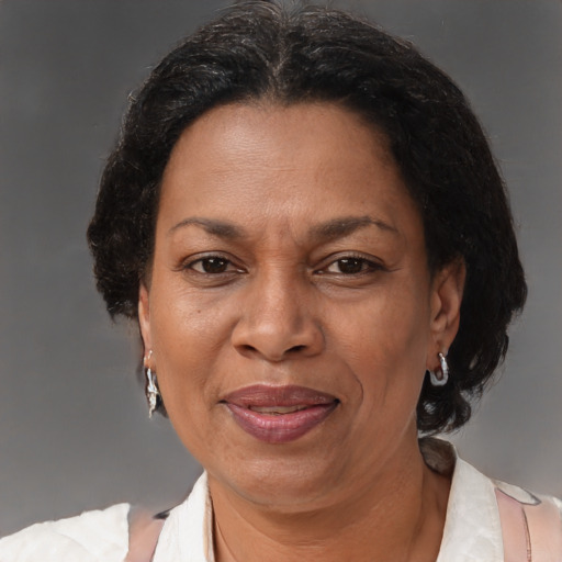 Joyful black adult female with medium  brown hair and brown eyes