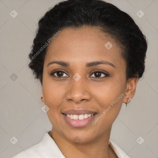 Joyful black young-adult female with short  black hair and brown eyes