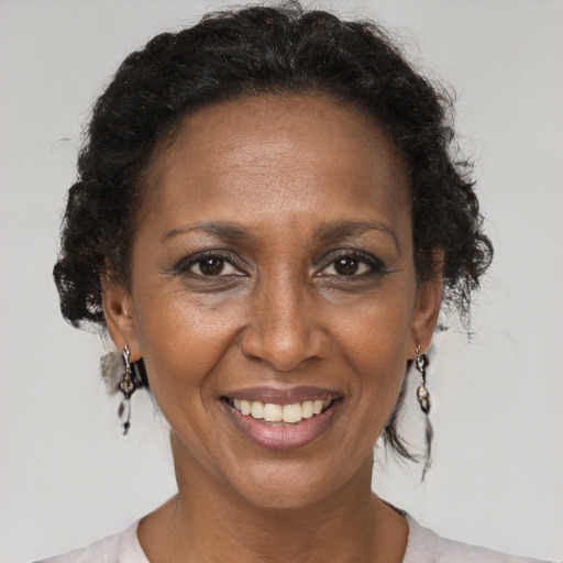 Joyful black adult female with short  brown hair and brown eyes