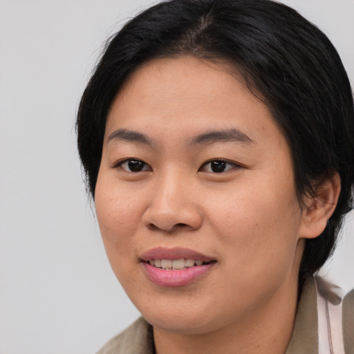 Joyful asian young-adult female with medium  brown hair and brown eyes