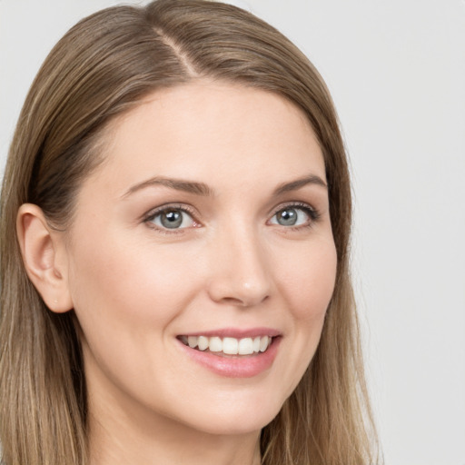 Joyful white young-adult female with long  brown hair and blue eyes