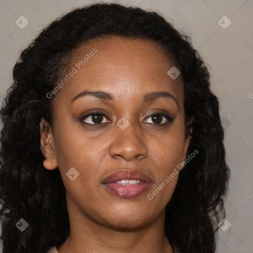 Joyful black young-adult female with long  brown hair and brown eyes