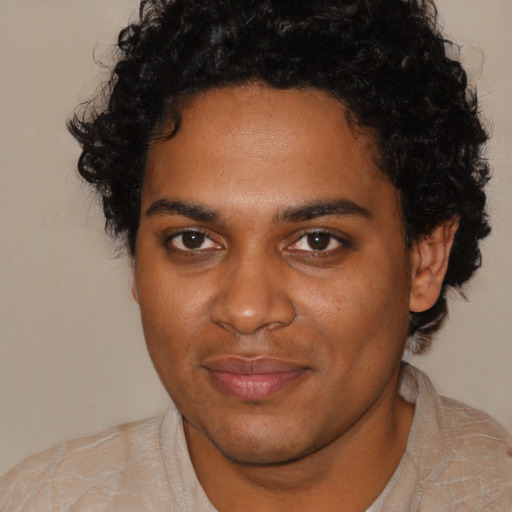 Joyful black young-adult male with short  brown hair and brown eyes