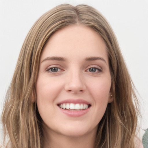 Joyful white young-adult female with long  brown hair and green eyes