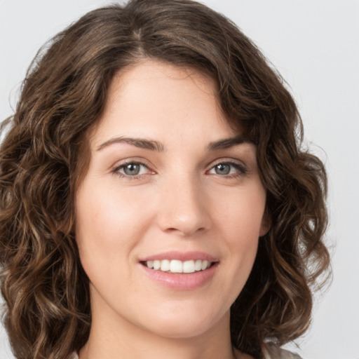 Joyful white young-adult female with medium  brown hair and green eyes