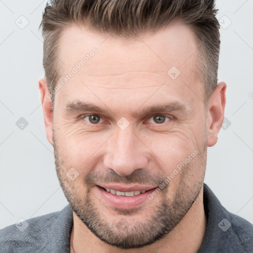 Joyful white adult male with short  brown hair and brown eyes