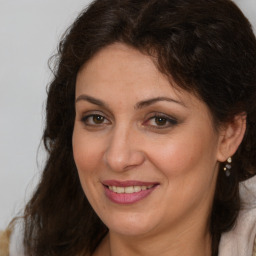 Joyful white adult female with long  brown hair and brown eyes