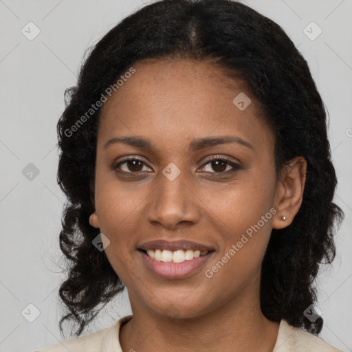 Joyful black young-adult female with long  black hair and brown eyes