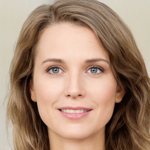 Joyful white young-adult female with long  brown hair and green eyes