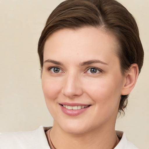 Joyful white young-adult female with medium  brown hair and brown eyes