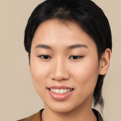 Joyful asian young-adult female with short  brown hair and brown eyes