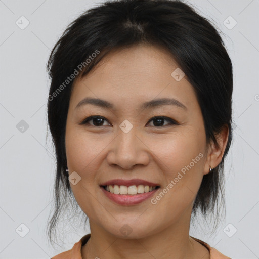 Joyful asian young-adult female with medium  brown hair and brown eyes