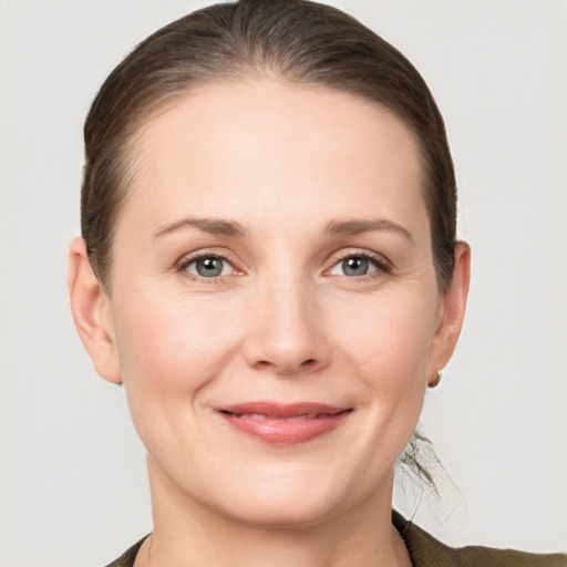 Joyful white young-adult female with medium  brown hair and grey eyes