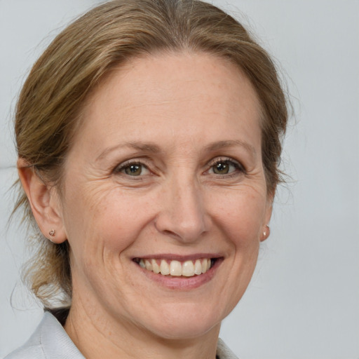 Joyful white adult female with medium  brown hair and brown eyes