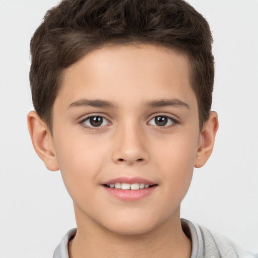 Joyful white child male with short  brown hair and brown eyes