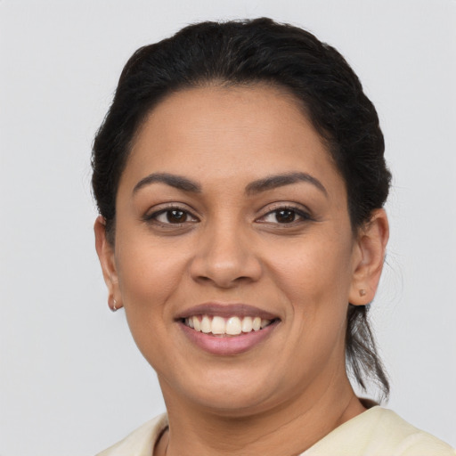 Joyful latino young-adult female with short  brown hair and brown eyes