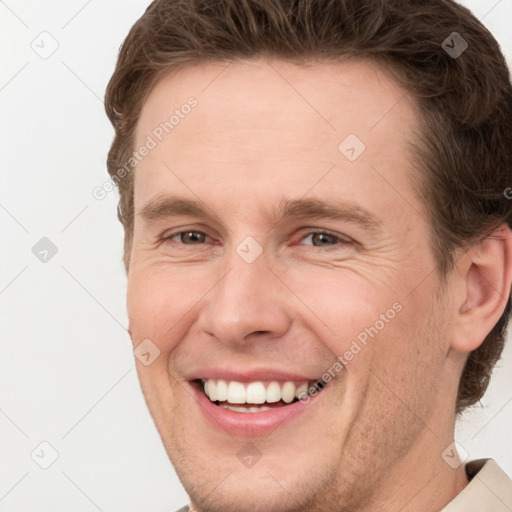 Joyful white adult male with short  brown hair and grey eyes