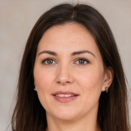 Joyful white adult female with long  brown hair and brown eyes