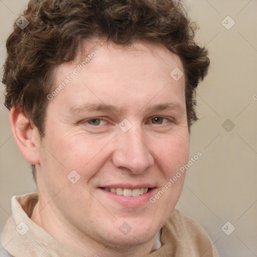 Joyful white adult male with short  brown hair and grey eyes